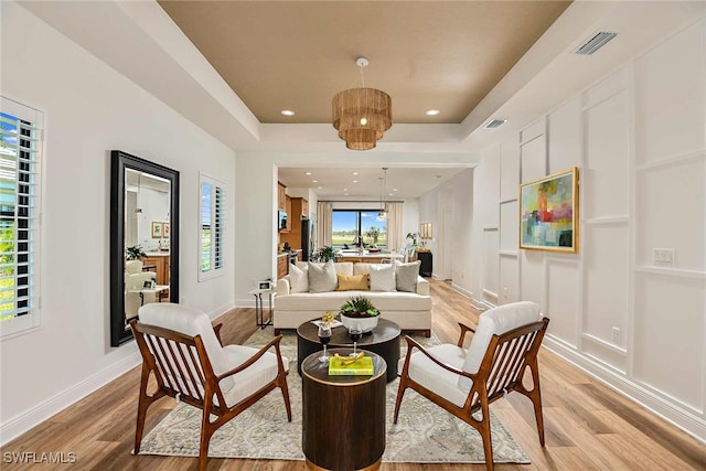 sitting room featuring plenty of natural light and light hardwood / wood-style flooring