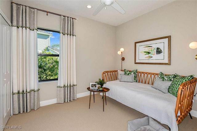 bedroom with a closet, light carpet, and ceiling fan