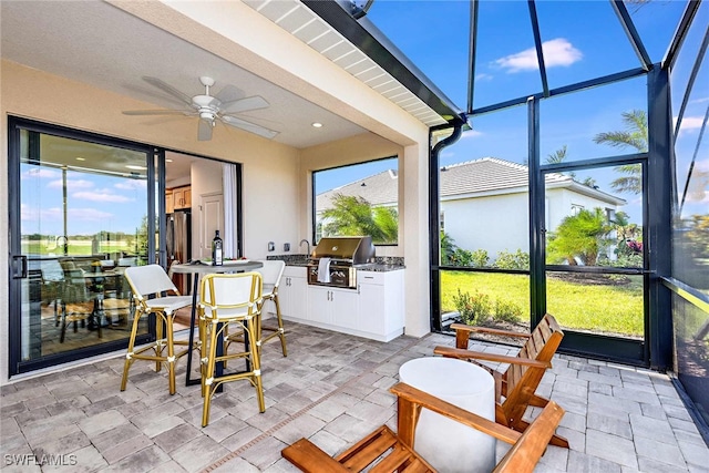 sunroom featuring ceiling fan