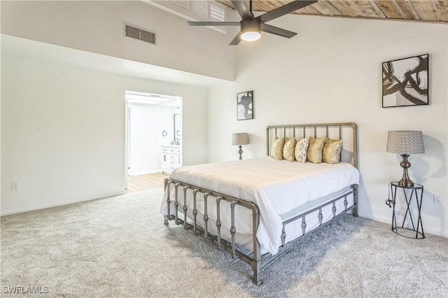 carpeted bedroom with ceiling fan, wood ceiling, connected bathroom, and high vaulted ceiling