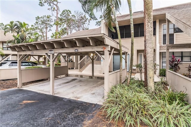 16448 Timberlakes Dr Unit 202, Fort Myers, FL 33908 - covered parking lot featuring stairs