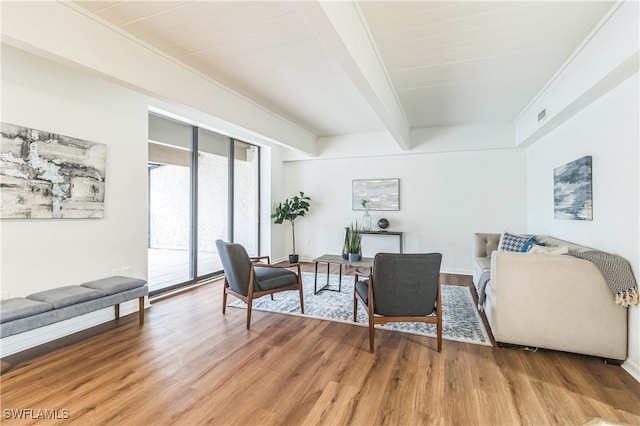 living room with beamed ceiling, wood ceiling, and hardwood / wood-style flooring