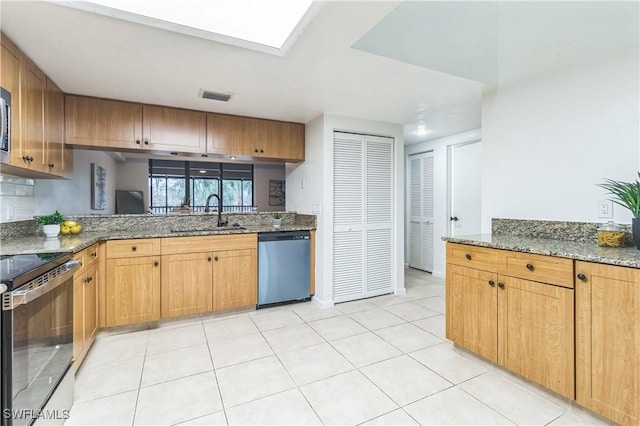 16448 Timberlakes Dr Unit 202, Fort Myers, FL 33908 - kitchen with stainless steel appliances, a sink, stone countertops, and light tile patterned floors