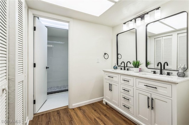 16448 Timberlakes Dr Unit 202, Fort Myers, FL 33908 - full bath featuring double vanity, a closet, wood finished floors, baseboards, and a shower