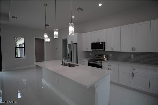 kitchen featuring a kitchen island with sink, white cabinets, sink, and stainless steel appliances