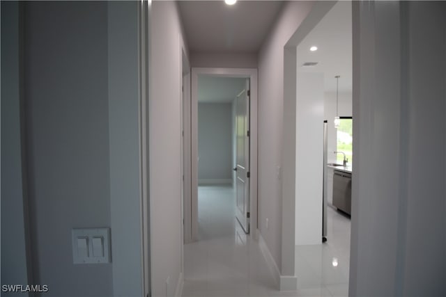 hallway featuring light tile patterned flooring