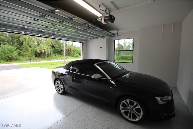 garage featuring a lawn, a carport, and a garage door opener