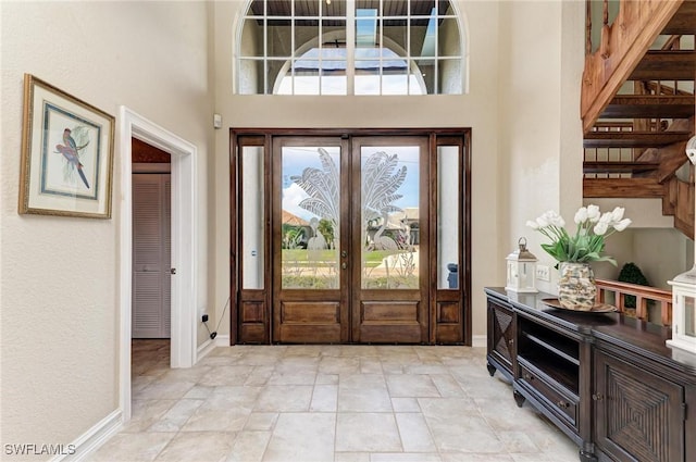 foyer with a high ceiling and french doors