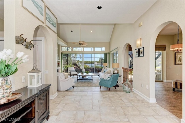 interior space with high vaulted ceiling and ceiling fan