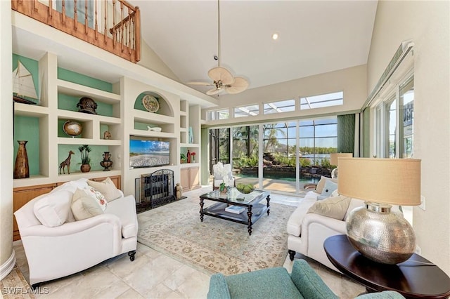 living room featuring built in shelves, high vaulted ceiling, and ceiling fan