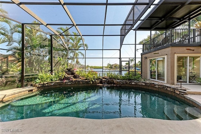 view of pool featuring glass enclosure