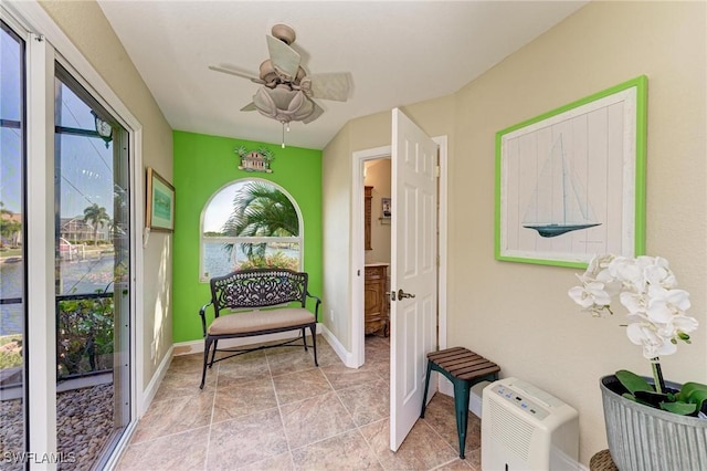 sunroom featuring ceiling fan