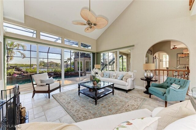 sunroom / solarium with a wealth of natural light, lofted ceiling, and ceiling fan