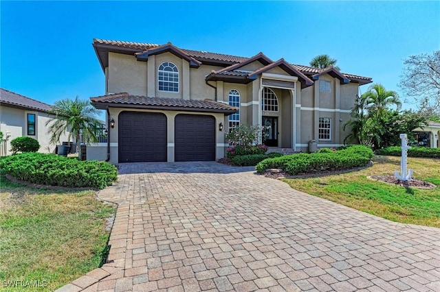 view of front of home with a garage and a front lawn