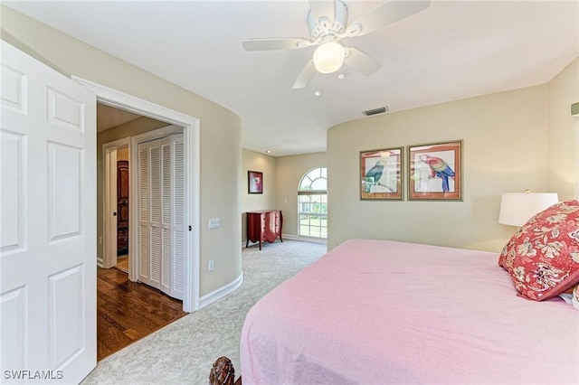 bedroom with ceiling fan, a closet, and dark hardwood / wood-style floors