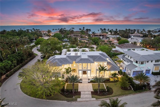 aerial view at dusk with a water view