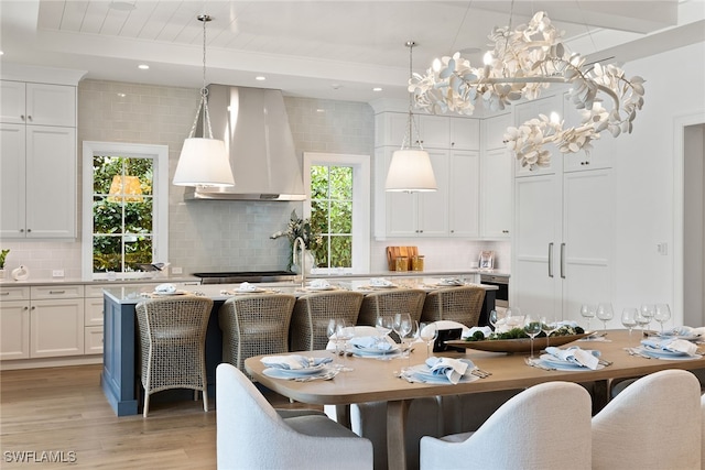 dining space featuring plenty of natural light, light hardwood / wood-style floors, and beam ceiling