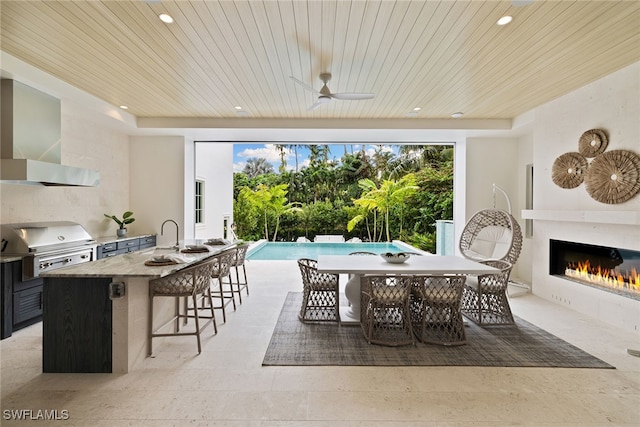 dining space featuring ceiling fan and wooden ceiling