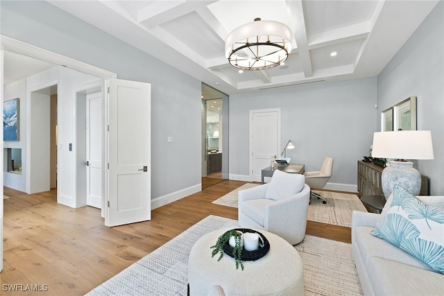 living room featuring beamed ceiling, light hardwood / wood-style floors, a notable chandelier, and coffered ceiling