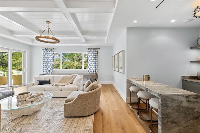 living room featuring beam ceiling, light hardwood / wood-style flooring, and coffered ceiling