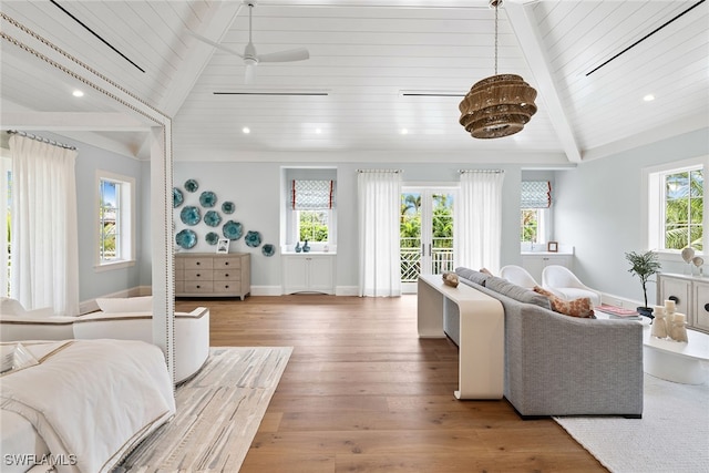 living room with ceiling fan, wood-type flooring, a wealth of natural light, and wooden ceiling