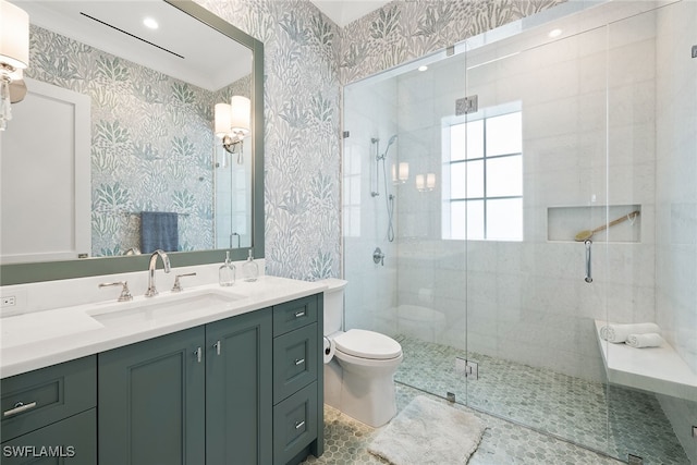 bathroom featuring tile patterned flooring, vanity, a shower with shower door, and toilet