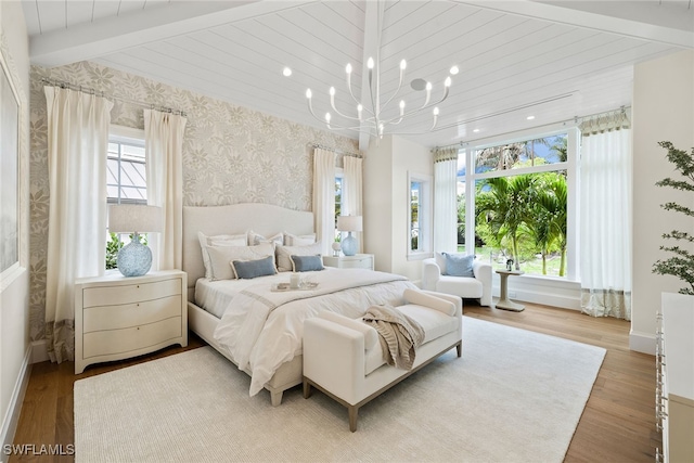 bedroom with vaulted ceiling with beams, light hardwood / wood-style floors, and a chandelier