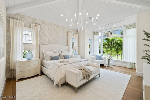 12 Sabre Ln, Naples, FL 34102 - bedroom with wallpapered walls, wood finished floors, and a chandelier