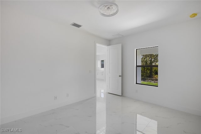 735 Goldrock Rd, Lehigh Acres, FL 33974 - unfurnished room featuring light marble finish floors, baseboards, and a smoke detector