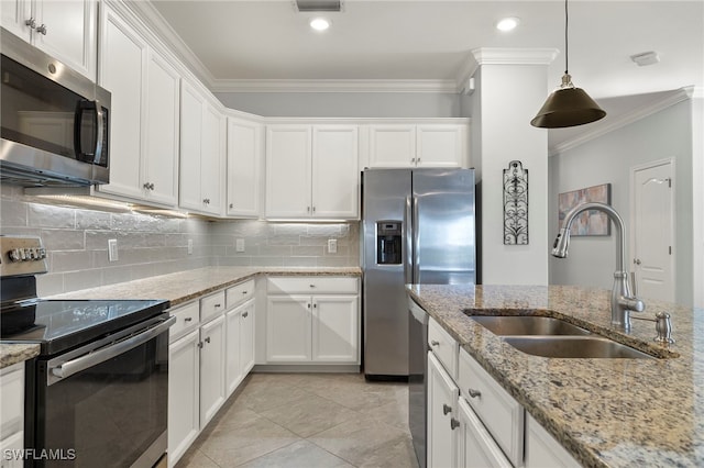 kitchen featuring stainless steel appliances, pendant lighting, white cabinets, light stone counters, and sink