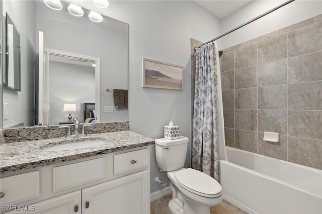 full bathroom with shower / bath combo with shower curtain, toilet, vanity, and tile patterned flooring