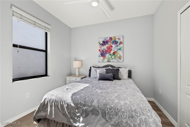 bedroom with ceiling fan and dark wood-type flooring