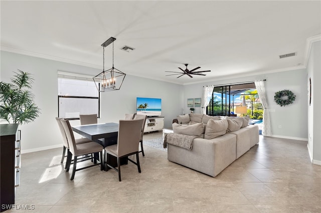 dining room with ceiling fan with notable chandelier and ornamental molding