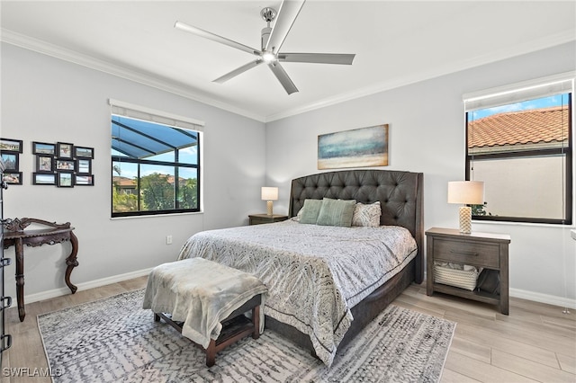 bedroom with ceiling fan, ornamental molding, and light hardwood / wood-style floors