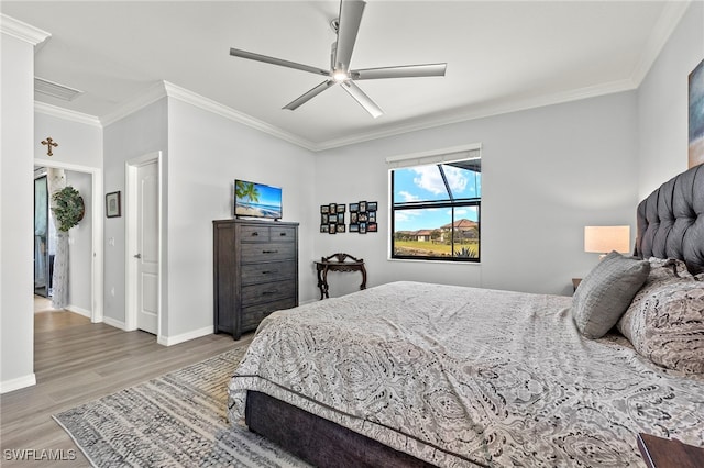 bedroom with ceiling fan, ornamental molding, and wood-type flooring