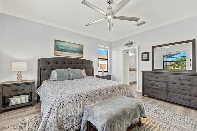 bedroom with ceiling fan, connected bathroom, light hardwood / wood-style flooring, and crown molding