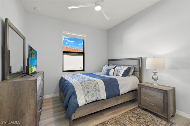 bedroom with light wood-type flooring and ceiling fan