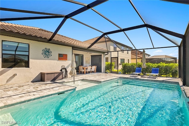 view of swimming pool with a lanai and a patio