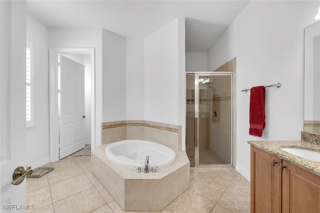 bathroom featuring tile patterned flooring, plus walk in shower, and vanity