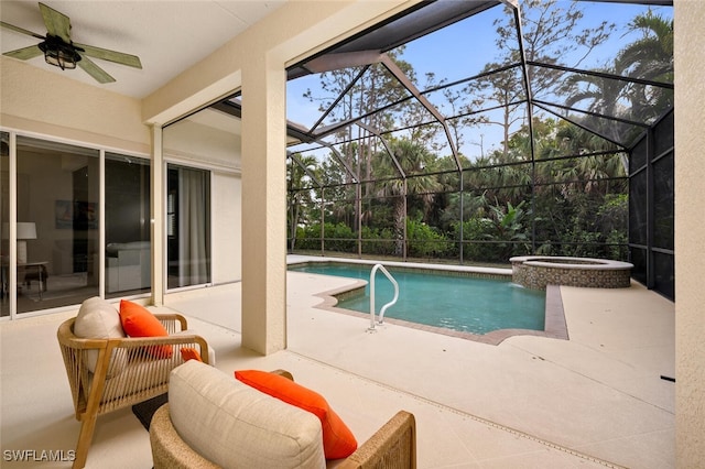 view of pool featuring an in ground hot tub, a patio area, and glass enclosure