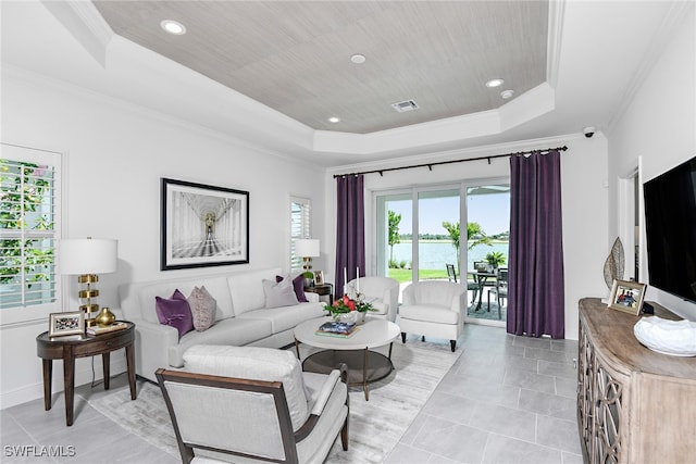 tiled living room featuring ornamental molding and a tray ceiling