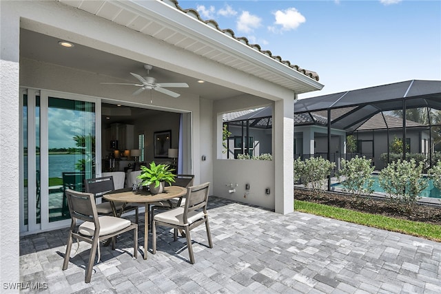 view of patio / terrace with ceiling fan, a lanai, and a pool