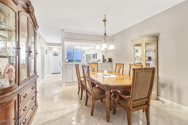 dining area with a chandelier and light tile patterned floors