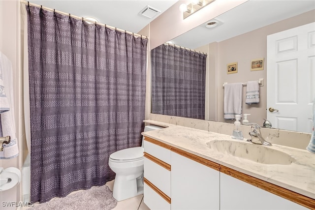 bathroom featuring toilet, vanity, and tile patterned floors