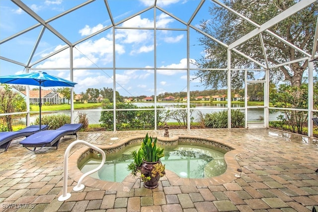 view of swimming pool with a lanai, a water view, a jacuzzi, and a patio area