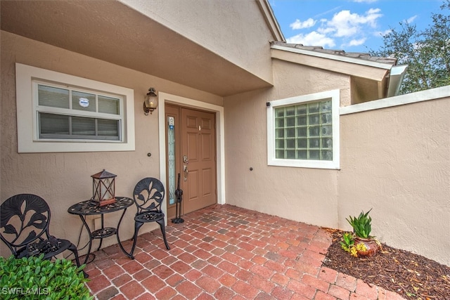 entrance to property featuring a patio area