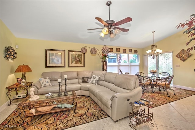 living room featuring ceiling fan with notable chandelier, light tile patterned flooring, and vaulted ceiling