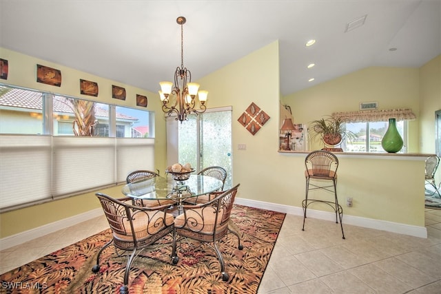 dining space with lofted ceiling, a chandelier, and light tile patterned floors