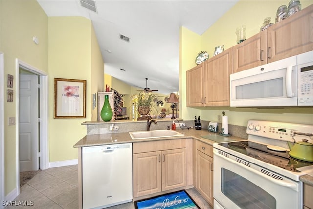 kitchen with sink, kitchen peninsula, light tile patterned floors, white appliances, and lofted ceiling