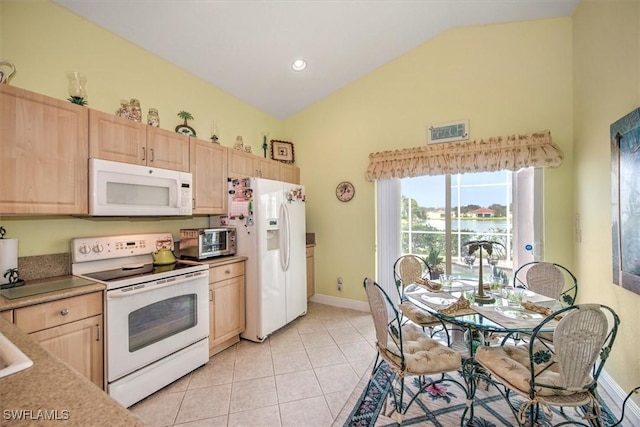 kitchen featuring white appliances, light brown cabinetry, high vaulted ceiling, baseboards, and light tile patterned flooring